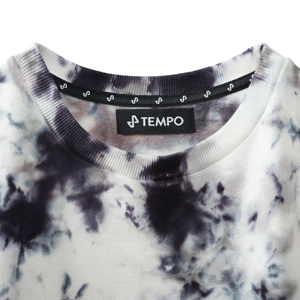Closeup of upper front of tie dye ascend sweatshirt showing tempo logo neck label