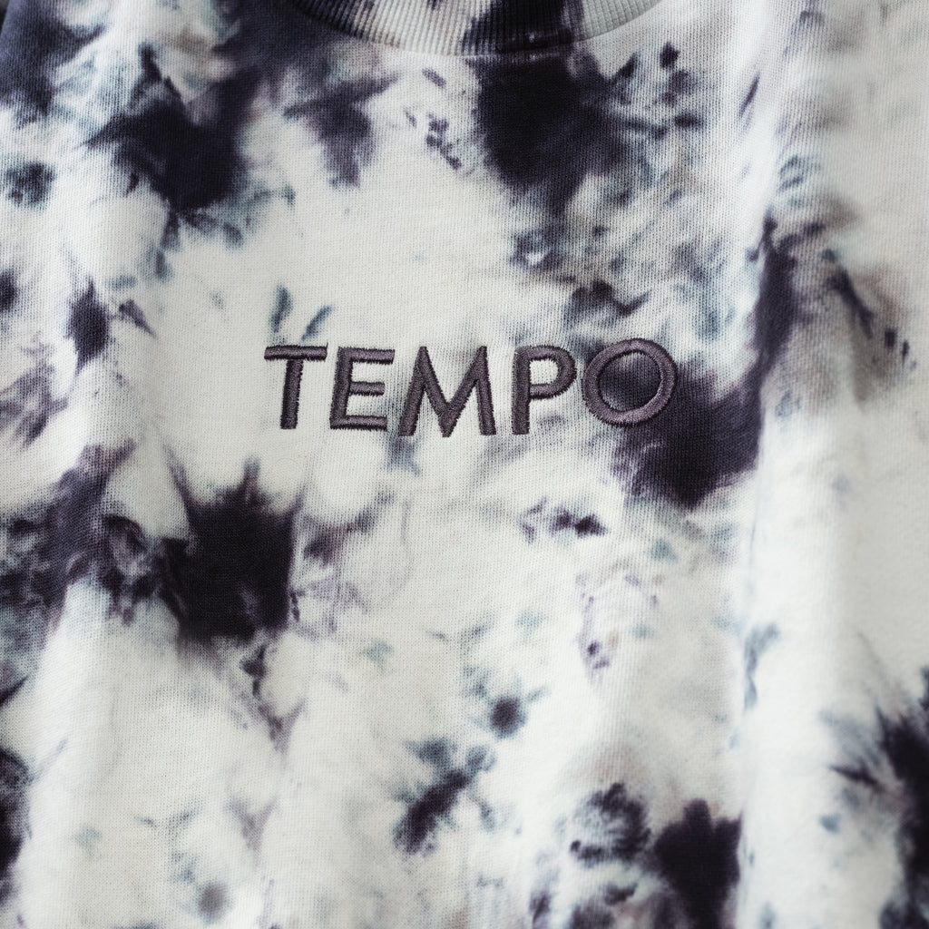 closeup of chest of Tie Dye Sweatshirt with TEMPO logo in center chest