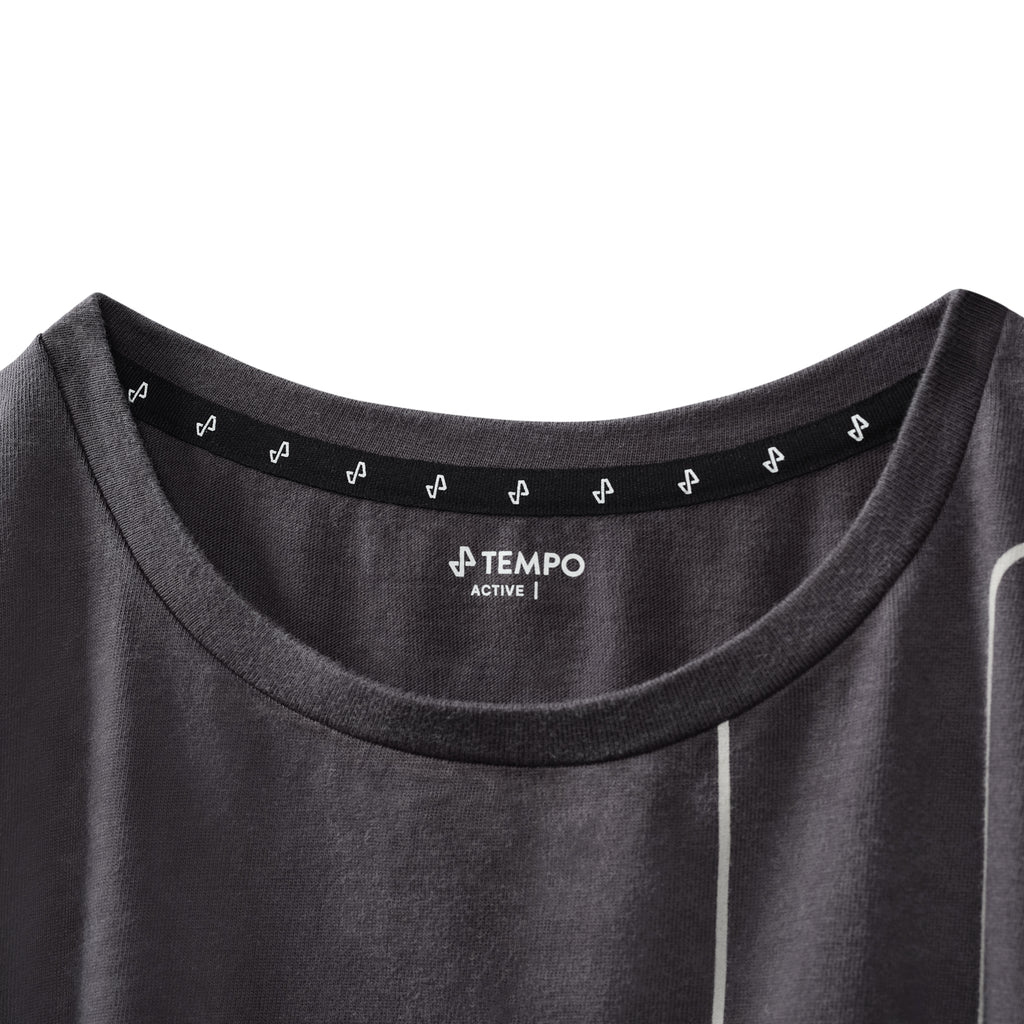 closeup of upper front of Grey Acidwash Stride Crop tee showing White Tempo Logo necklabel and active text