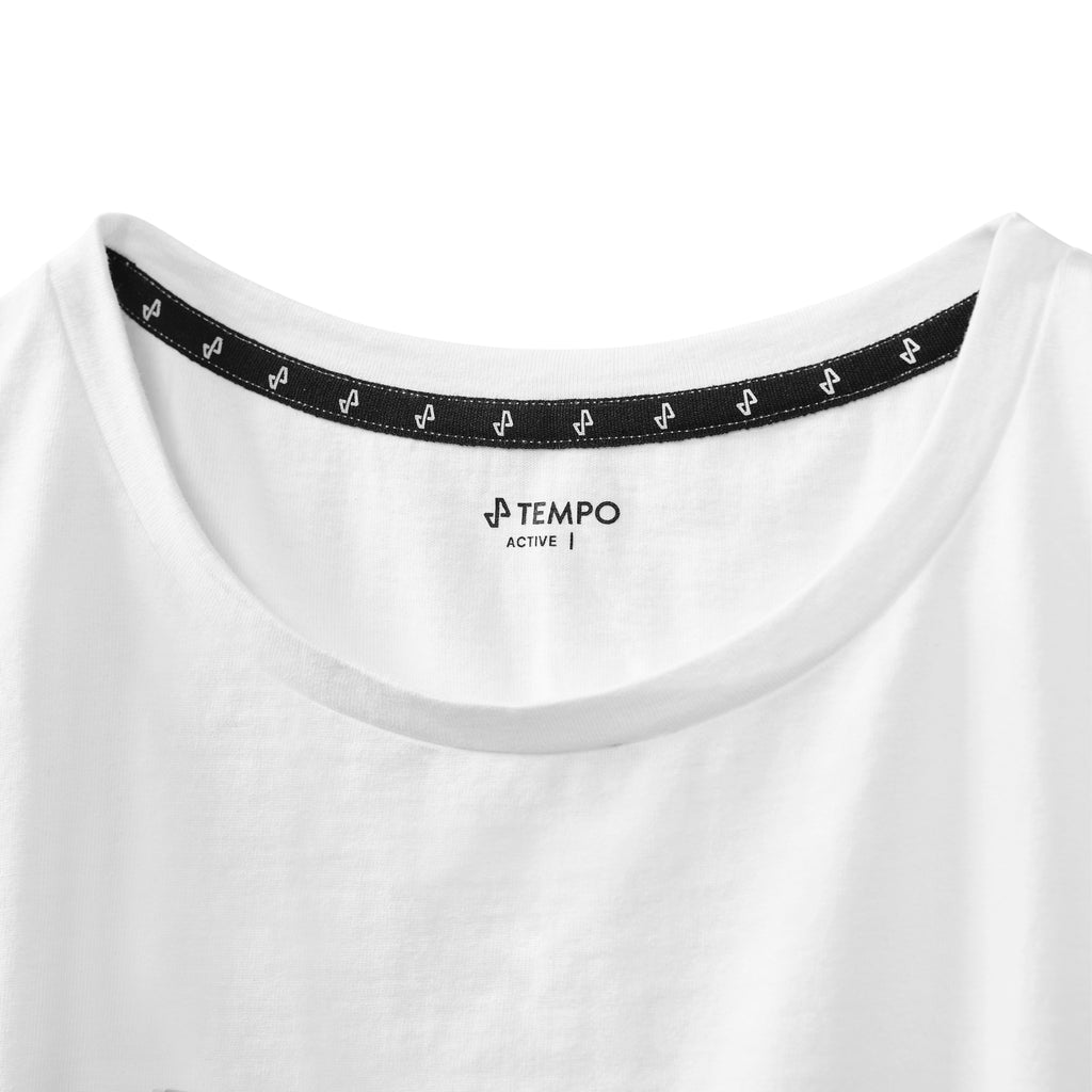 closeup of white Stride Crop Tee showing black neck label with Tempo logo and active text